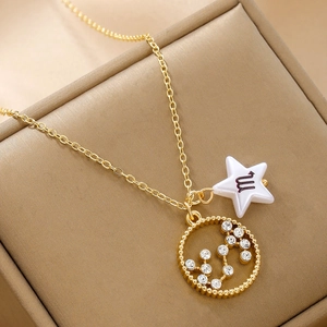 Detail of a gold Scorpio zodiac necklace with rhinestone constellation and star charm