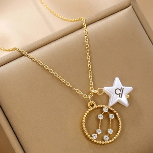 Detail of gold constellation necklace with rhinestone circle and star charm pendant