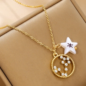 Detail of gold alloy necklace with star pendant and sparkling zircon studded ring