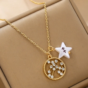 Macro view of gold Sagittarius necklace with rhinestone-inlaid pendant on leather box