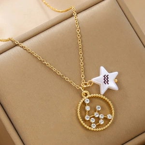 Detailed macro view of gold Aquarius zodiac necklace with sparkling crystal star charms