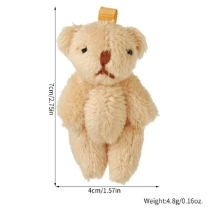 Close-up of small beige plush bear with gold ribbon loop showing 7cm height dimensions
