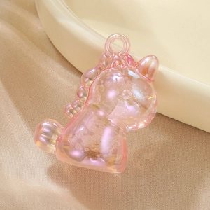 Pink unicorn bag charm with iridescent finish and glittery quicksand effect inside