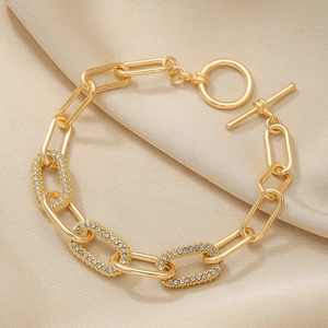 Elegant gold oval link bracelet with sparkling rhinestones and a stylish OT clasp