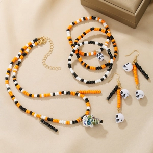 Beaded Halloween jewelry set with skull and spider web charms in orange black and white