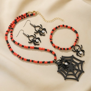 Halloween beaded jewelry set featuring red and black beads with spider and web charms