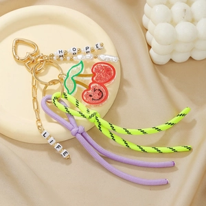 Detail of keychain featuring HOPE and LIFE beads with cherry charm on satin