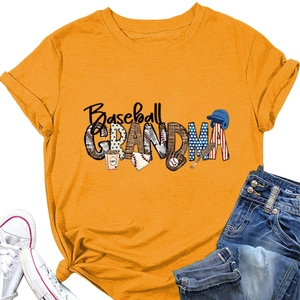 Flat lay of yellow Baseball Grandma T-shirt with baseball themed graphics and white shoes