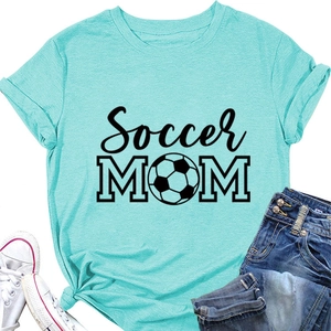 Flat lay detail of a mint green soccer mom T-shirt with denim shorts and white sneakers