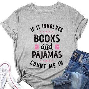 Flat lay of gray cotton T-shirt with books and pajamas slogan next to blue jeans