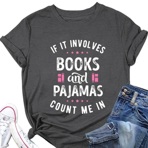 Flat lay of charcoal t-shirt with books and pajamas slogan, jeans and white sneakers