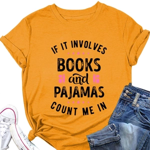 Detail of yellow cotton T-shirt with book slogan print, shorts and white sneakers