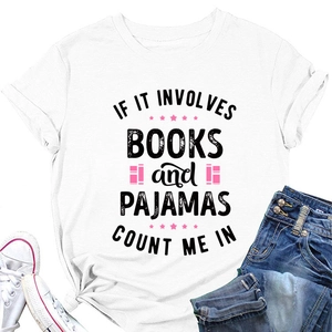 Flat lay of white cotton T-shirt featuring Books and Pajamas quote with denim jeans
