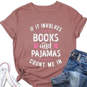 Flat lay of pink cotton T-shirt with books and pajamas text slogan and denim jeans