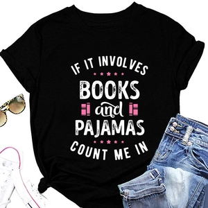 Flat lay of black slogan t-shirt with sunglasses, sneakers and denim shorts