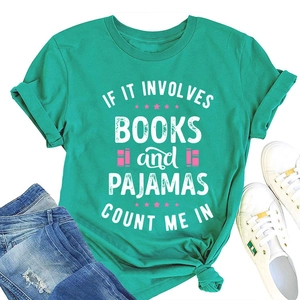 Flat lay of mint green slogan t-shirt with books and pajamas print and denim jeans