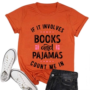 Detail of orange t-shirt with books and pajamas text print styled with jeans