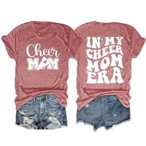 Flat lay of rust red Cheer Mom T-shirt and distressed denim shorts summer set