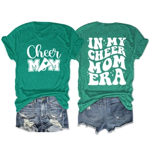 Detail of green cotton t-shirt with Cheer Mom graphic prints and casual denim shorts