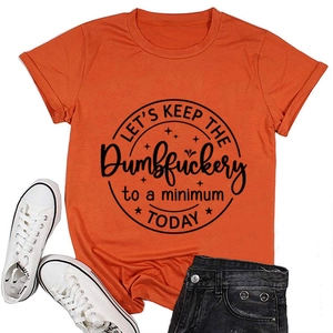 Flat lay of an orange cotton T-shirt with black graphic print, jeans and white sneakers