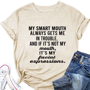 Detail of loose beige T-shirt with black slogan print and stylish crew neck design