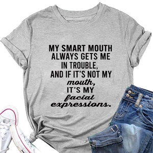 Flat lay of grey crew neck T-shirt with black slogan print, jeans and sneakers