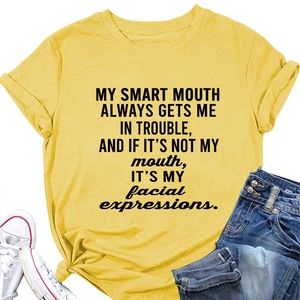 Detail of yellow cotton T-shirt with black slogan print and stylish side knot detail