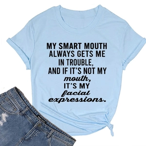 Close-up of light blue round neck T-shirt with text print and trendy front hem knot detail
