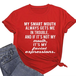 Detail of red crew neck T-shirt featuring a side-knot hem and white slogan typography