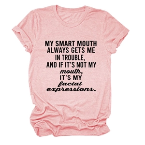 Detail of pink heathered cotton t-shirt featuring bold black slogan and round neckline