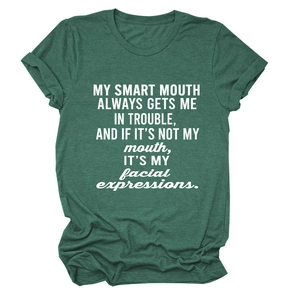 Close-up of white lettering print on a dark green heather crewneck short sleeve t-shirt