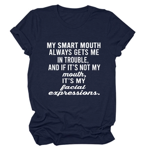 Detailed close-up of navy blue cotton T-shirt with white humor quote and rolled sleeves