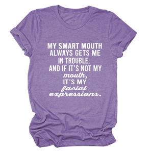 Detail of white screen print text on a purple crew neck loose casual t-shirt