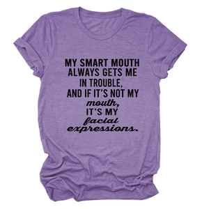 Detail of purple cotton blend T-shirt fabric with black slogan print on the chest