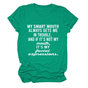 Detailed view of emerald green cotton T-shirt featuring white smart mouth slogan print