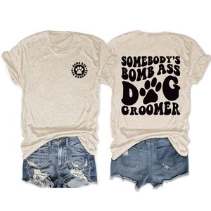 Flat lay of oatmeal cotton t-shirt and denim shorts with dog groomer print details