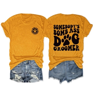Detail view of ginger dog groomer t-shirt with screen print and denim shorts