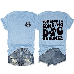 Light blue t-shirt with dog groomer print and denim shorts set on white background