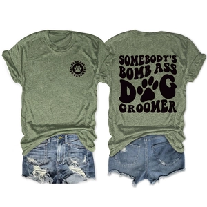 Detail view showing front and back prints of the green dog groomer graphic t-shirt