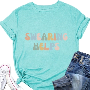 Flat lay of a mint green t-shirt with 'Swearing Helps' text and casual summer outfit