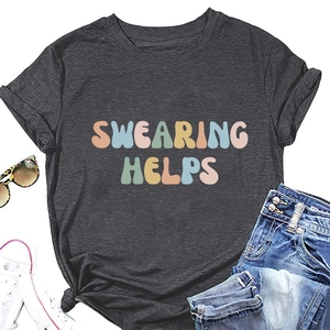Flat lay of charcoal grey t-shirt with colorful Swearing Helps text and denim shorts