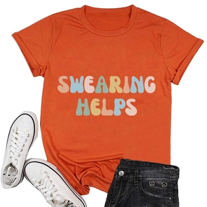 Detail of orange cotton T-shirt with Swearing Helps text, denim shorts and sneakers