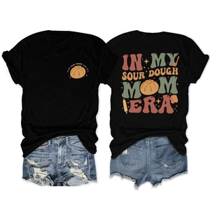 Flat lay of sourdough mom era t-shirt with front and back prints and denim shorts