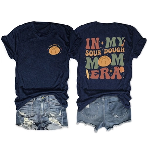 Flat lay of sourdough mom era navy t-shirt and distressed denim shorts summer set