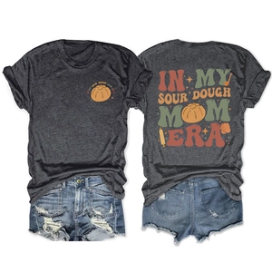 Flat lay of sourdough mom era t-shirt showing front and back prints with denim shorts