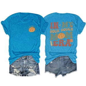 Flat lay of sourdough mom era t-shirt with back print and ripped denim shorts