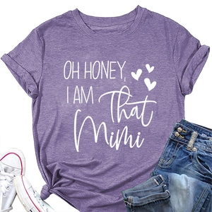 Flat lay of purple cotton T-shirt with white OH HONEY I AM THAT MIMI print and blue jeans