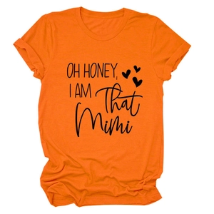 Flat lay of an orange round neck t-shirt featuring OH HONEY I AM THAT MIMI graphic print