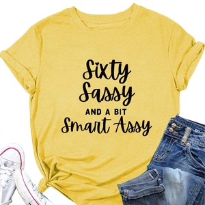 Flat lay of yellow t-shirt with Sixty Sassy print paired with denim shorts and shoes