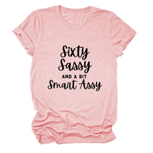 Close-up of pink round neck T-shirt with black sixty sassy and smart assy slogan